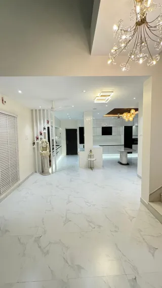 Hall with chandelier and marble flooring