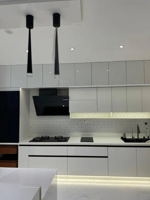 Kitchen with pendant lights and black chimney