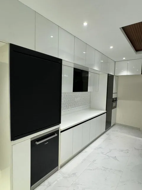 Kitchen with tall black glass units