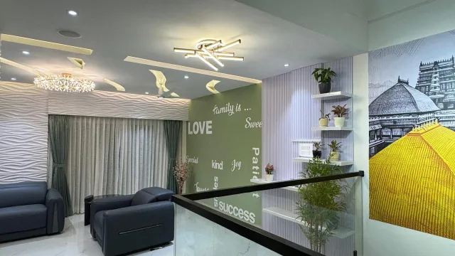 Living room with green feature wall and open staircase