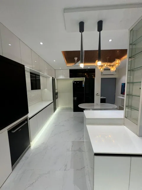 Open kitchen with island counter and pendant lights