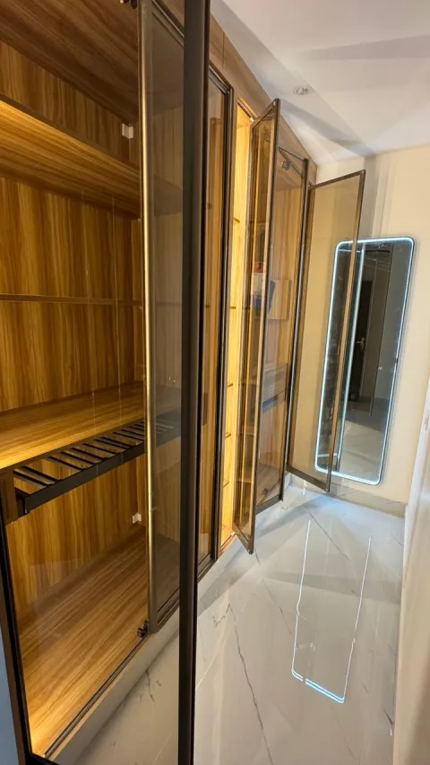 Wooden wardrobe interior with profile lighting